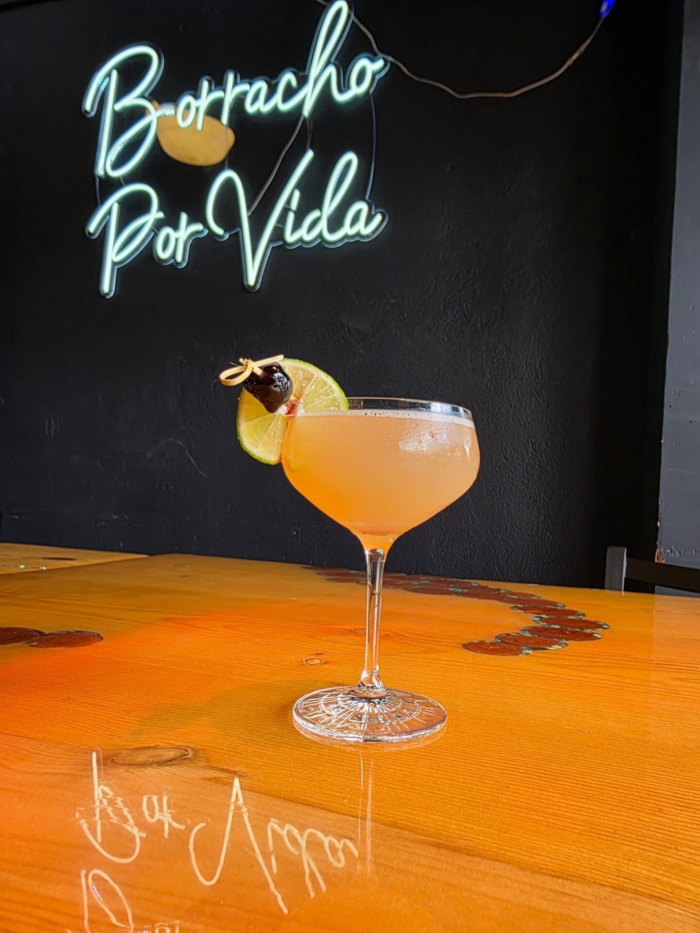 The Hemingway Daiquiri at Borracho's, Borracho Por Vida sign behind it