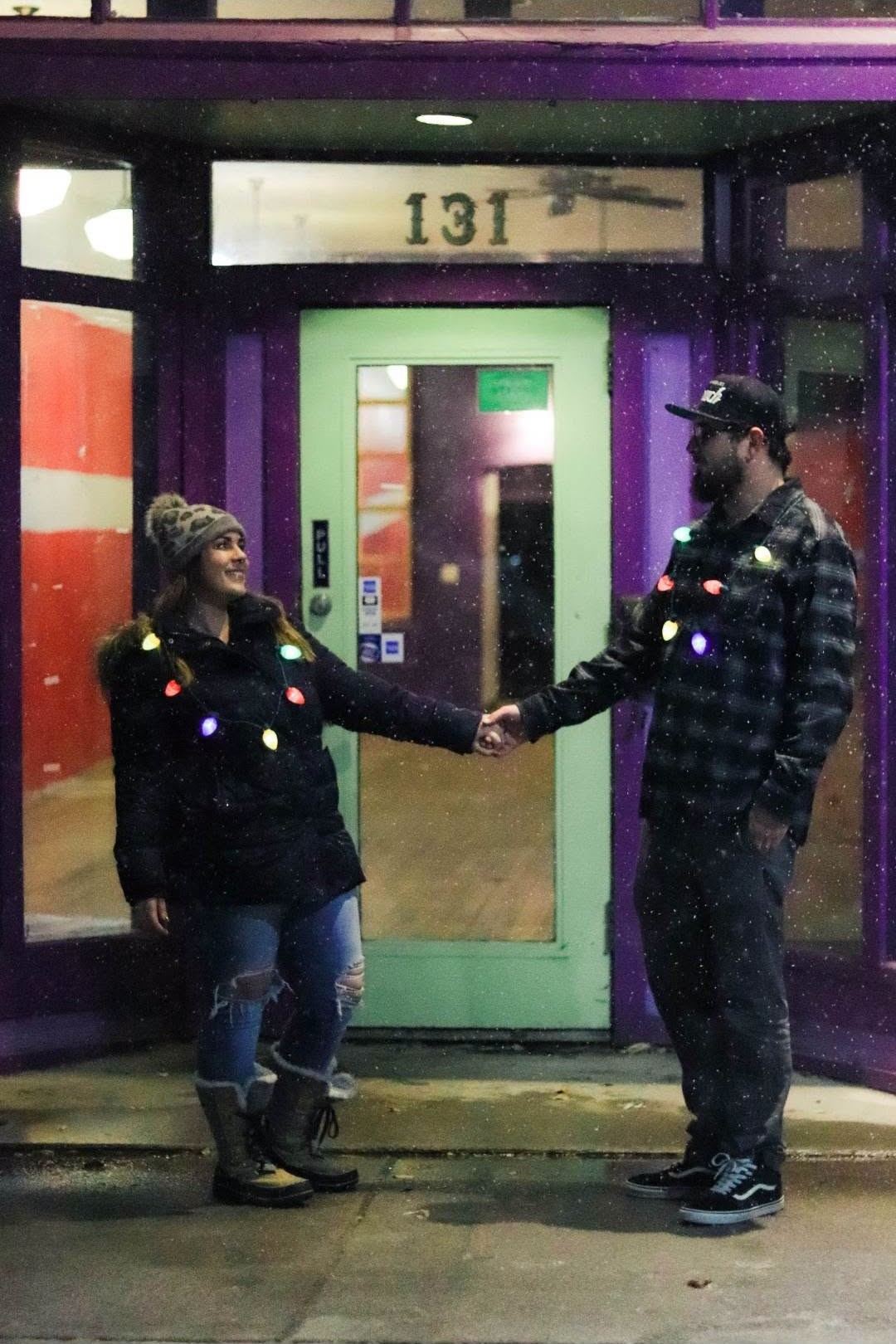 Ryan and Sara Jo holding hands outside the building's front entrance