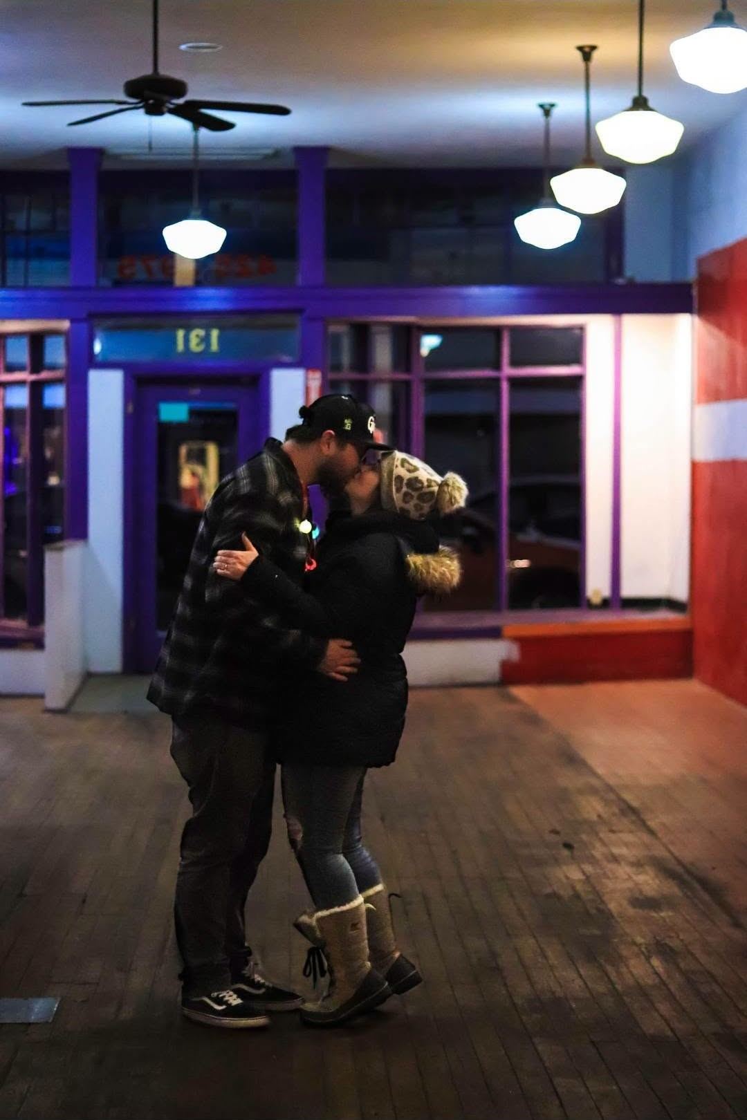 Ryan and Sara Jo embracing inside the empty building, freshly engaged