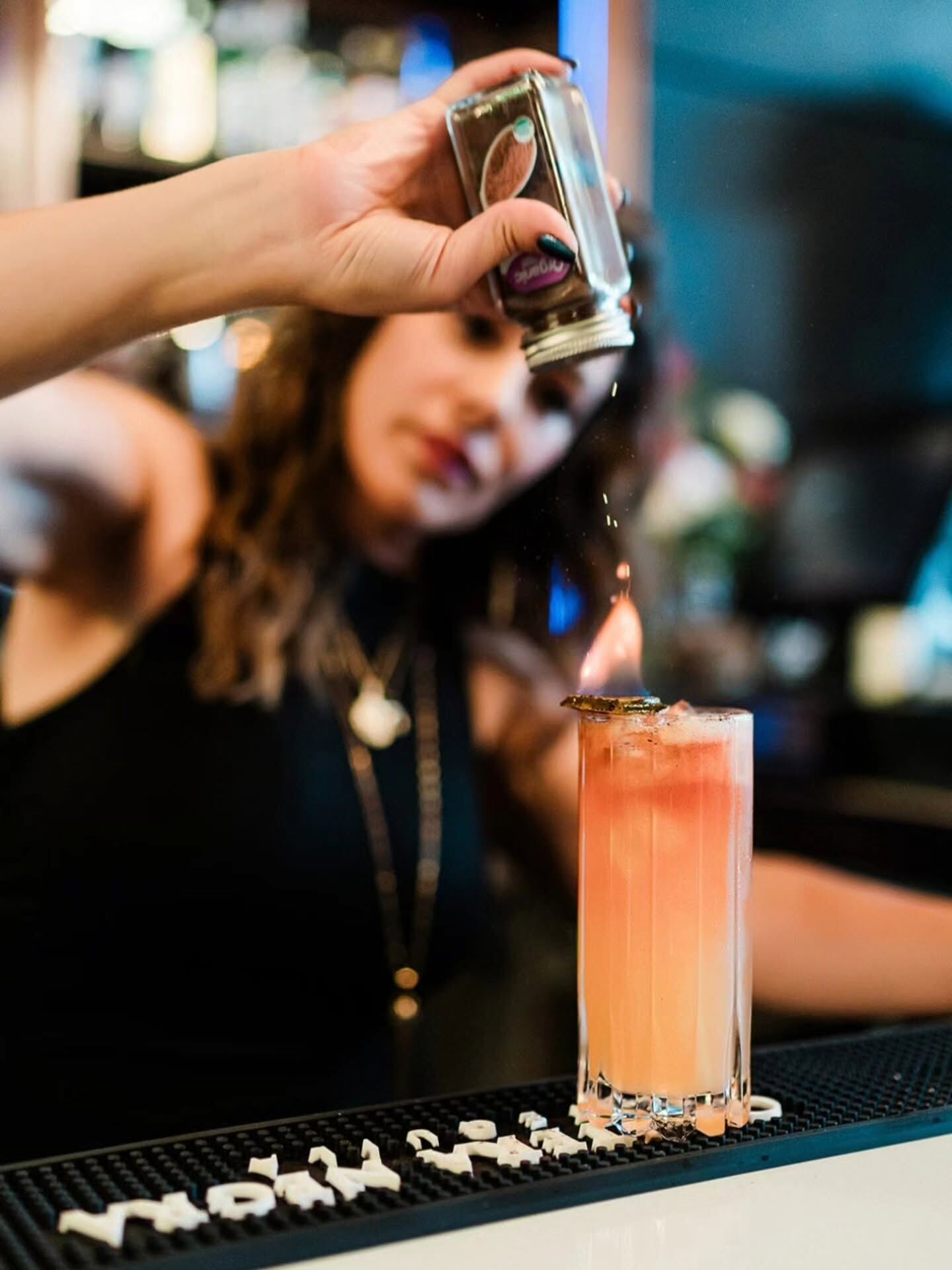 Bartender finishing a flaming cocktail at Borracho's